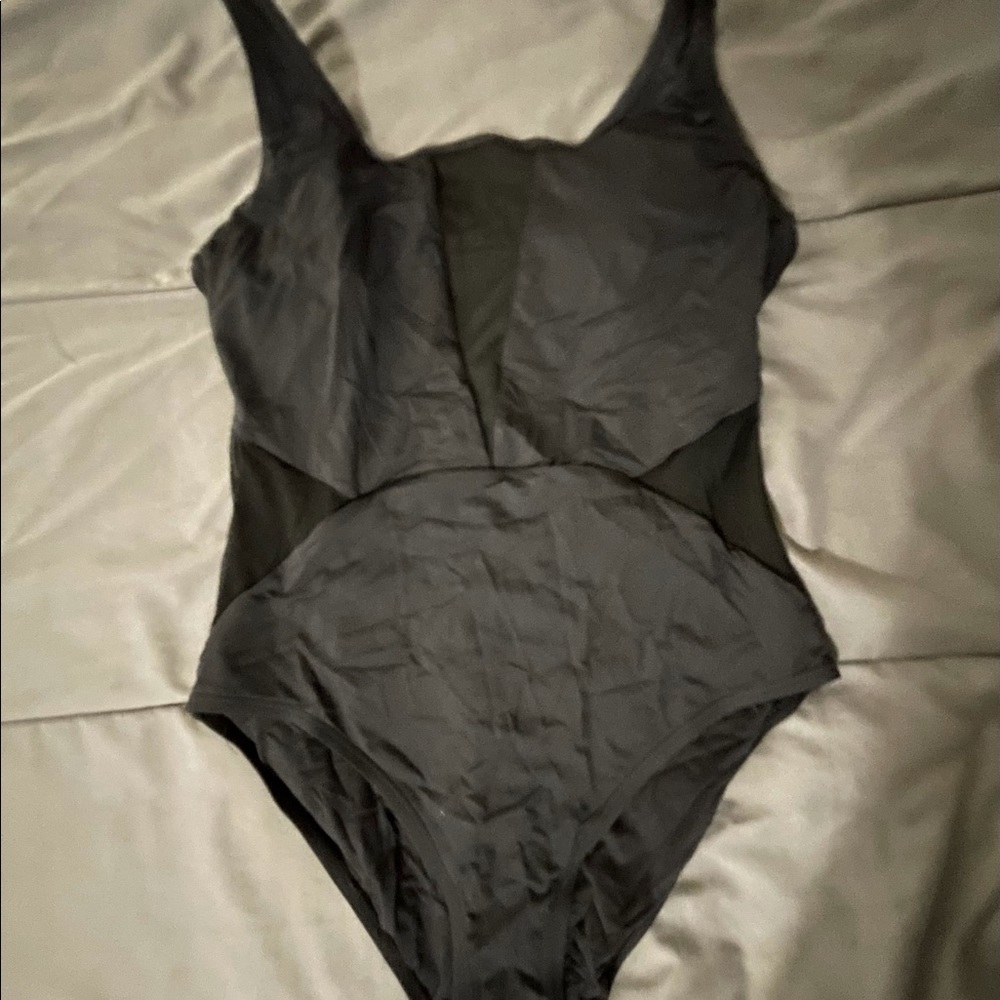Black one piece swimsuit with some see through mesh